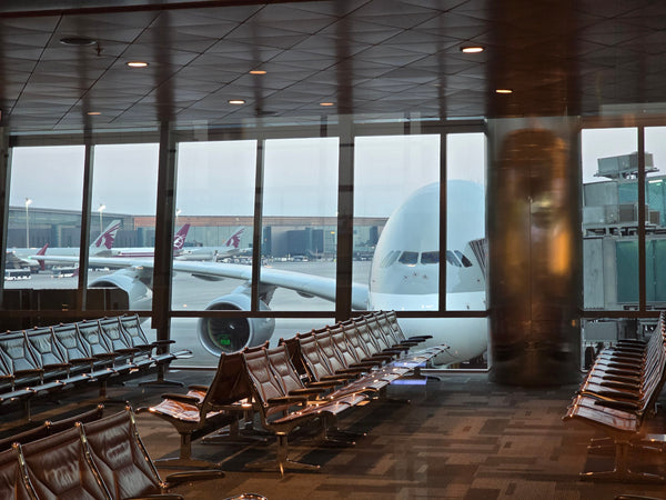Passenger plane viewed from the seating area at Hamad International Airport in Doha