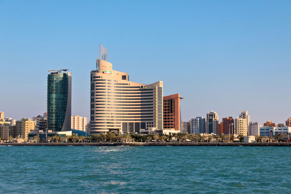 Kuwait City skyline and waterfront under a clear sky