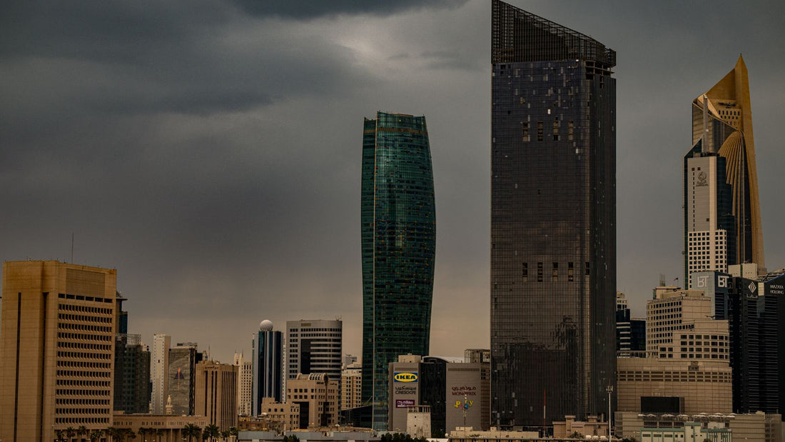 Office skyscrapers under cloudy skies in Kuwait City