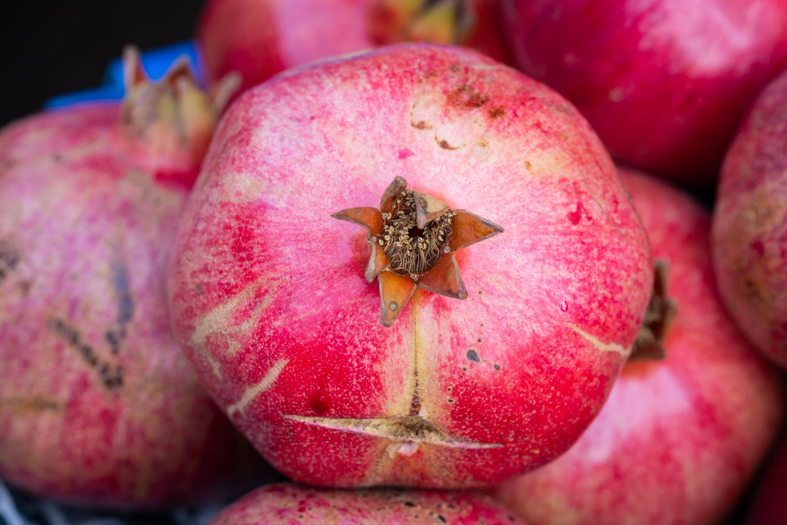 High-resolution close-up of ripe organic pomegranates showcasing texture and vibrant color.
