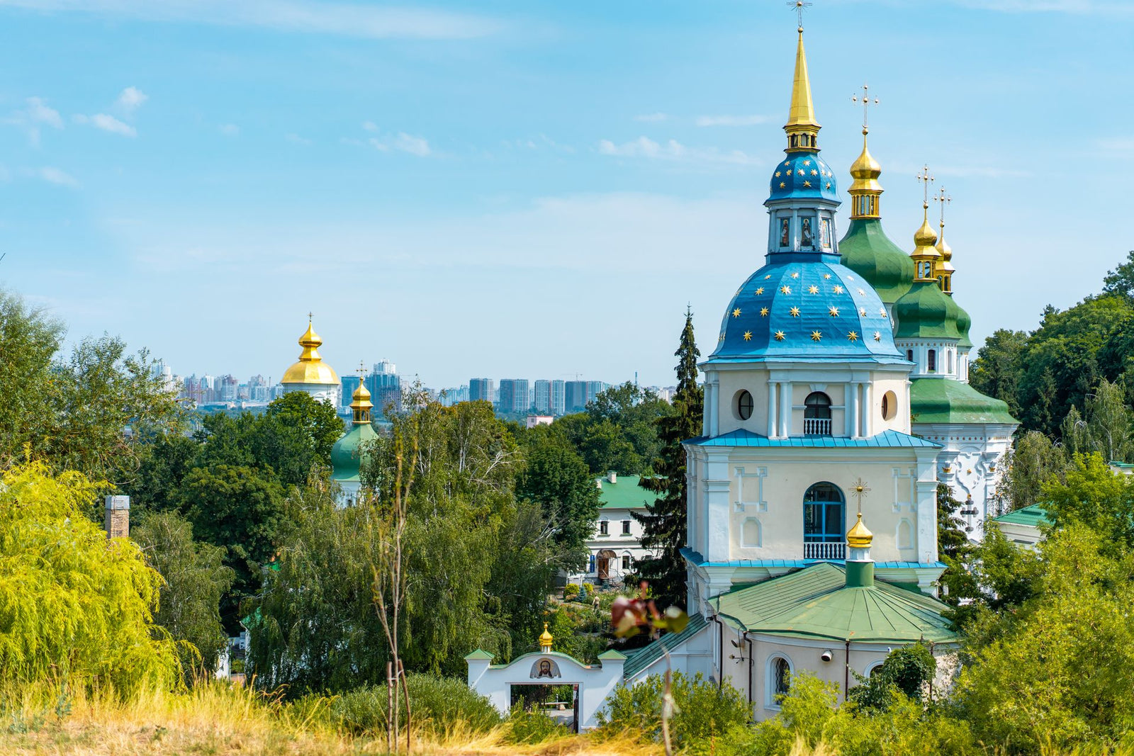 Scenic view of St. Michael's Golden-Domed Monastery in Kyiv, Ukraine with clear blue sky.