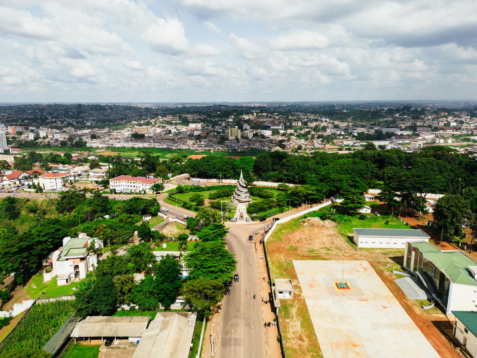 A stunning aerial shot of the Reunification Monument in Yaoundé, Cameroon showcasing urban beauty.