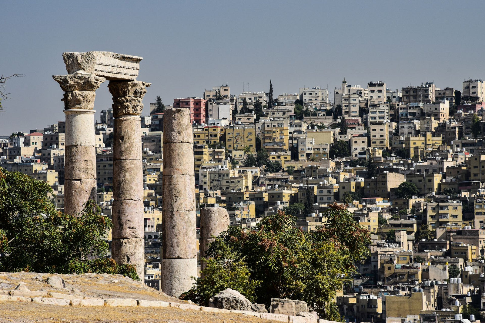 Roman ruins and modern Amman cityscape in Jordan captured in a single frame.