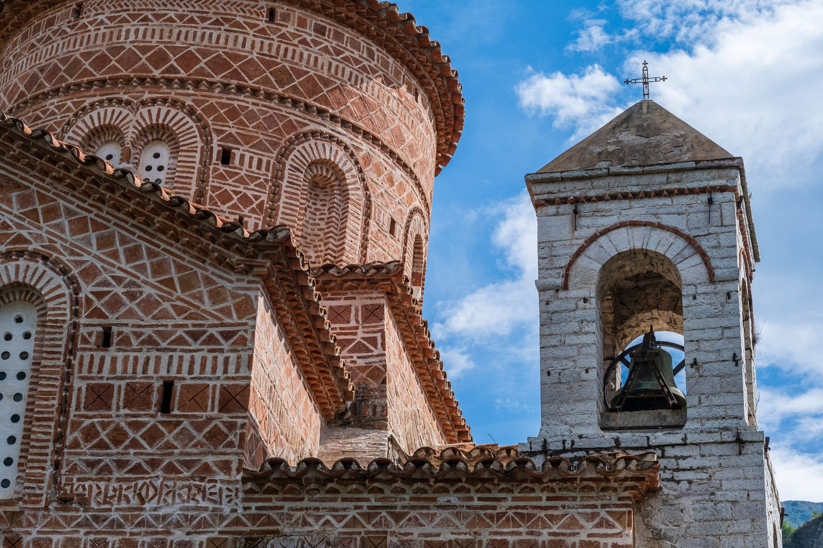 Close-up of a historic Byzantine church facade in Albania under a blue sky.