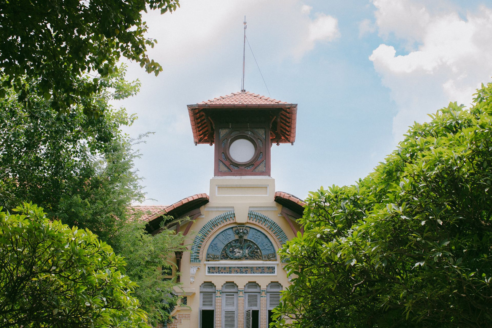 Old French colonial building with ornate details in Ho Chi Minh City, Vietnam.