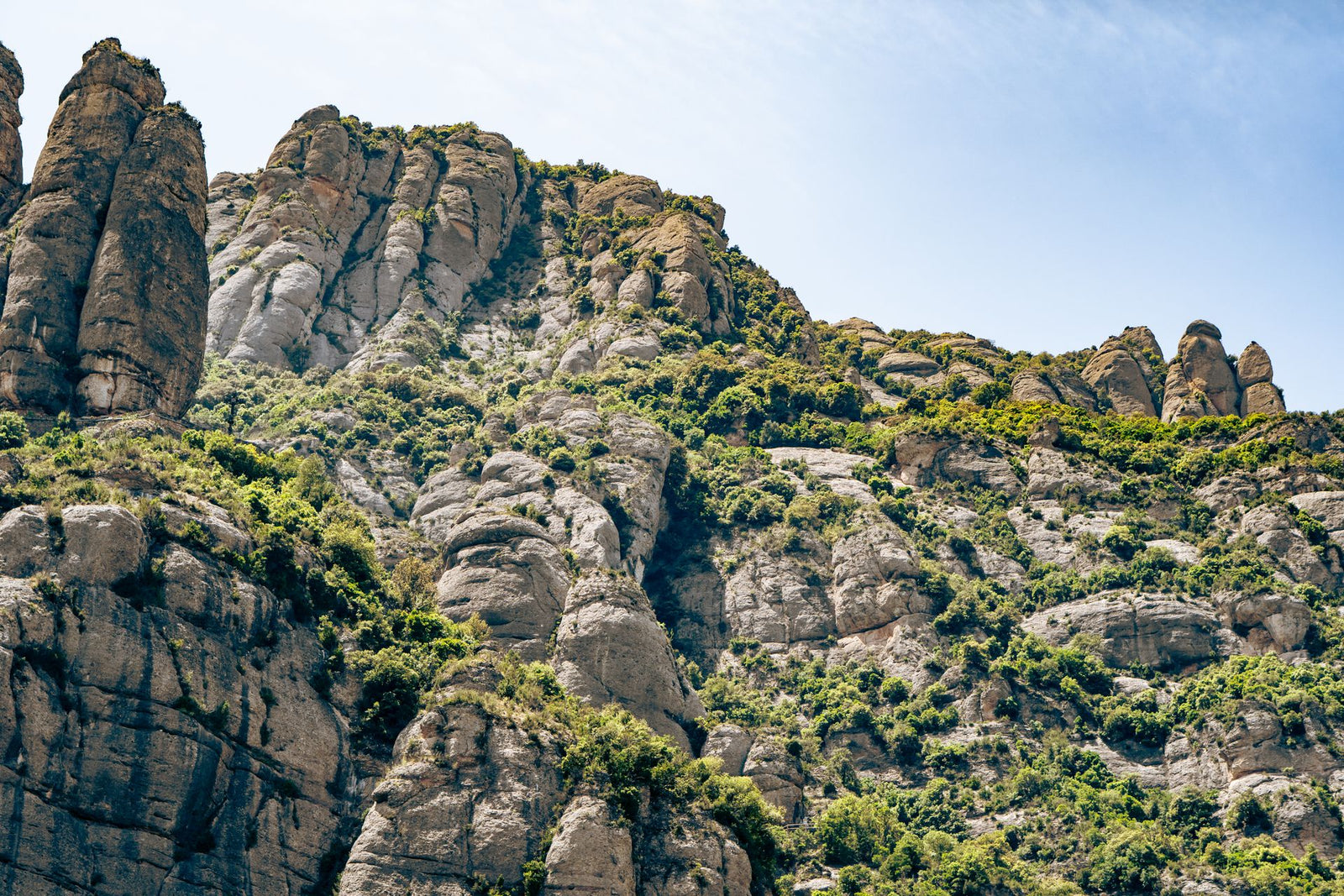 Breathtaking view of the Montserrat mountains' unique rock formations under clear blue skies.