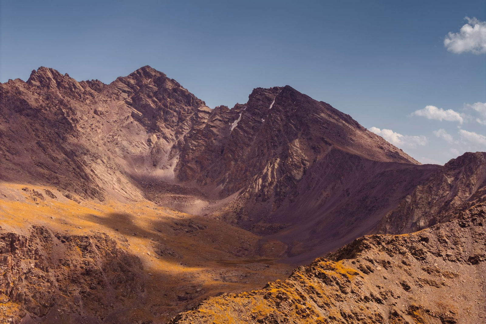 A stunning view of rugged mountains under a clear blue sky in Kyrgyzstan.