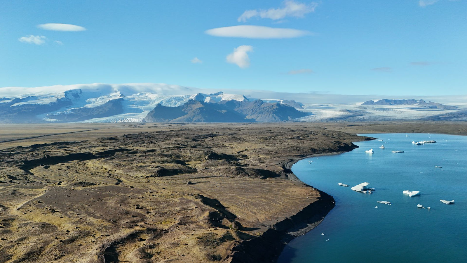 Stunning aerial view of Iceland's glacier and lake showcasing natural beauty and ice formations.