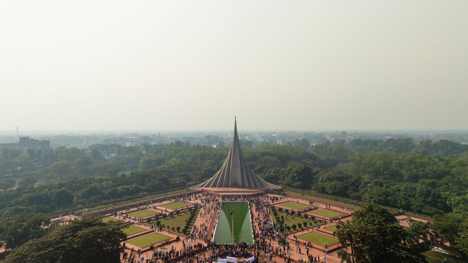 Stunning aerial view of the National Martyrs' Memorial in Savar, Bangladesh, surrounded by lush greenery.
