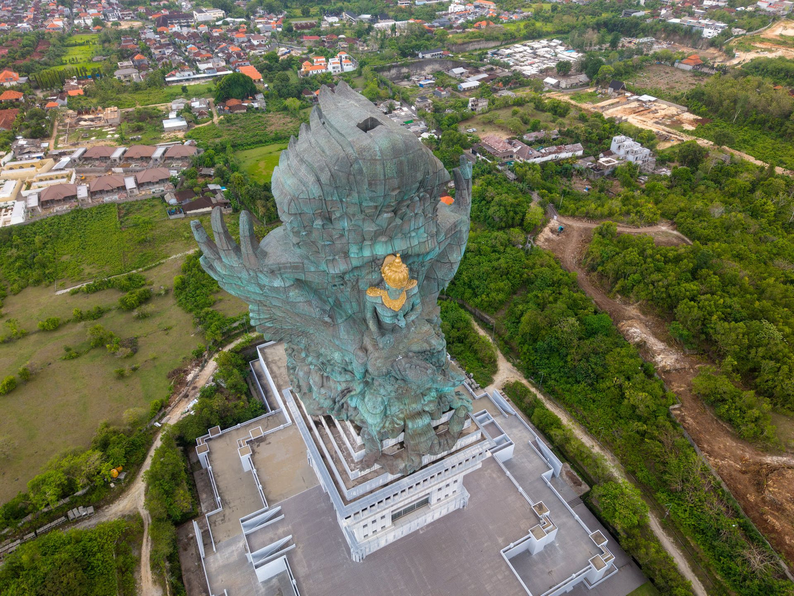 Stunning aerial view of Garuda Wisnu Kencana statue and surrounding landscape in Bali, Indonesia.