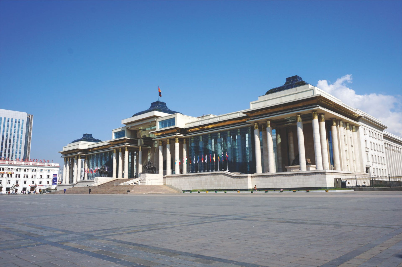 The Mongolian Government Palace in Sukhbaatar Square under a clear blue sky.