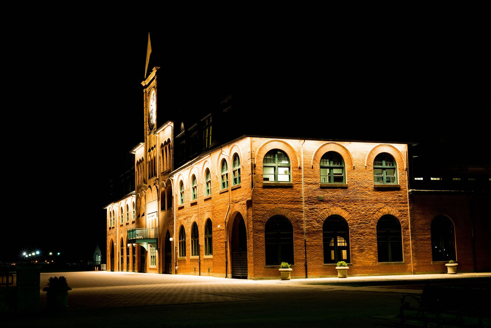 A beautiful brick building with arched windows illuminated at night in Jackson Township, New Jersey.